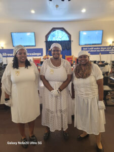 Women Ushers pause for a moment together after fulfilling their duties at the Divine Healing Service during Showers of Blessings 2026.